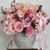 This stunning floral arrangement is a true showstopper, featuring pink roses and