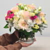 This charming bouquet features delicate peach and pink Garden Roses, complemented by
