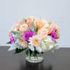 This charming bouquet features delicate peach and pink Garden Roses, complemented by