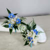 The blue and white boutonni&egrave;re offers a refreshing twist on the classic