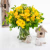 Beautiful yellow floral arrangement with ranunculus, spray roses, freesias, and tulips. We