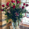 About 27 inches tall. This arrangement includes star gazer lilies, hot pink