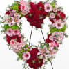 Heart Shaped Funeral Piece Filled with an Assortment of Beautiful Flowers in
