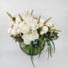 In a clear vase, an arrangement made of 2 dozen peonies, a