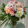 Designer Choice of Peach and Pastel Tone Floral in Glass Vase Arrangement