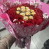 This red roses and chocolate bouquet wrapped in Dior designer paper perfect