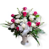 This funeral arrangement has pink and white roses, white mums, snapdragons, and