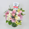 A medium arrangement made with hydrangeas, roses, cymbidium orchids, eryngium, and greenery
