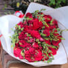 A beautiful hand bouquet of long-stemmed roses wrapped in paper. 
Standard Price