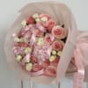 This beautiful bouquet mixes soft pink and white roses with fluffy pink