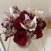 Dozen red roses with orchid blooms and pink wax cut to fit
