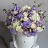 A delicate composition of lavender tulips, lisianthus, and roses nestled in an