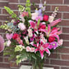 Hand-delivered in a shapely glass vase, this sumptuous arrangement of roses and