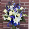 Featuring lilies, roses, stock, iris and larkspur. 