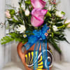 This arrangement contains a pottery cup with roses, spray roses, poms and