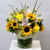 This stunning flower arrangement in a cylinder vase is a harmonious blend