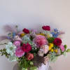 A soft, romantic arrangement where blush-toned flowers bloom among shimmering pearl accents&mdash;evoking