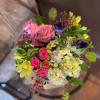 Delight her with these vibrant blooms! Designed in a clear upscale hourglass