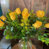 Dozen long stem yellow roses designed in a glass vase.