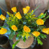 Dozen long stem yellow roses designed in a glass vase.