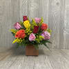 Mixed roses in a glass square vase. 