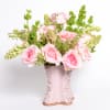 An arrangement of pink roses and tuberose in a handmade ceramic high-gloss