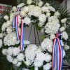 Peonies(Sesasonal), Roses, Cremons, Mums, Hydrangea, Babies Breath, Ferns Fancy Greens, Ribbon.

Call Store