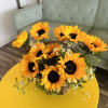 A charming basket with 10 sunflowers, daisies, and greenery.