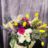 Puppy in spring basket gifts variety of custom florist picks flowers in