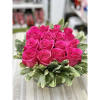 Arrangement: Roses arranged in a unique crystal vase with greens and a