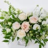 Neutral elegant arrangement that features white, nude and green florals in our