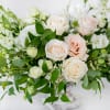 Neutral elegant arrangement that features white, nude and green florals in our