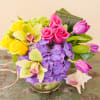 A vivid and lush design featuring vibrant pink and yellow roses, purple