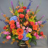 Uplifting and heartwarming. This bold display of gerber daisies, hydrangea, roses, delphinium