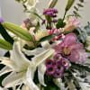 A breathtaking composition of pristine lilies, delicate pinks, and soft lavenders, artfully