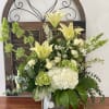 A green and white bouquet in wooden box.