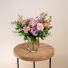 This gorgeous arrangement features a stunning mix of purple and pink blooms