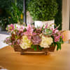 This unique arrangement features a lush collection of long-lasting flowers, such as