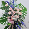 Monstera.  Roses. Gerbera.  Eyc dollar. Blue Delphinium 