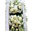 This standing two-tiered wreath is for funeral services and features all-white flowers