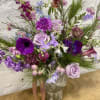 Beautiful moss cement vase filled with premium varieties of purples and blues