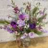 Beautiful moss cement vase filled with premium varieties of purples and blues