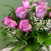 Purple roses, delicately complemented by the ethereal beauty of Baby&#039;s Breath, and