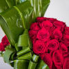Elegant Low and compact red Rose arrangement accented with Ti Leaves.
Containers subject