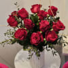  A simple but elegant display of vibrant red roses. Arranged with