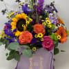Mix of flowers arranged in a box.