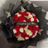 A stunning arrangement of 100 white and red roses is beautifully handcrafted