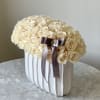 All white roses in our white vase 

Fresh cut roses