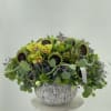 Bright green arrangement of fresh flowers in the white ceramic vase