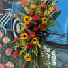 Seasonal tropical flowers arranged in spray. 


